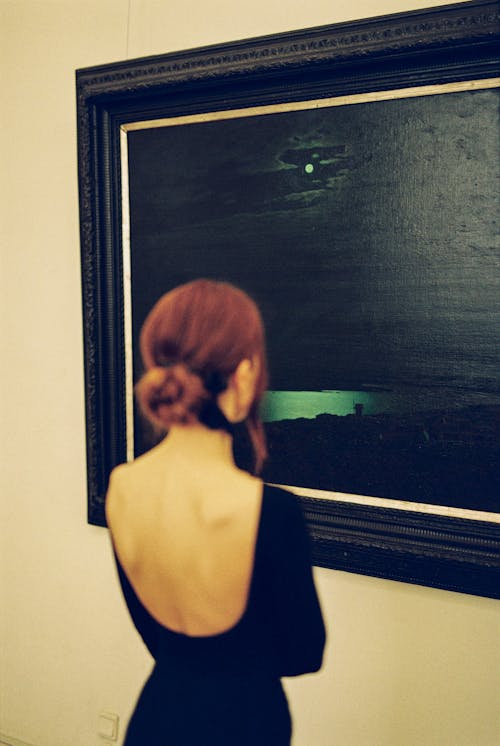 Free Woman in Black Dress Looking at a Painting Stock Photo