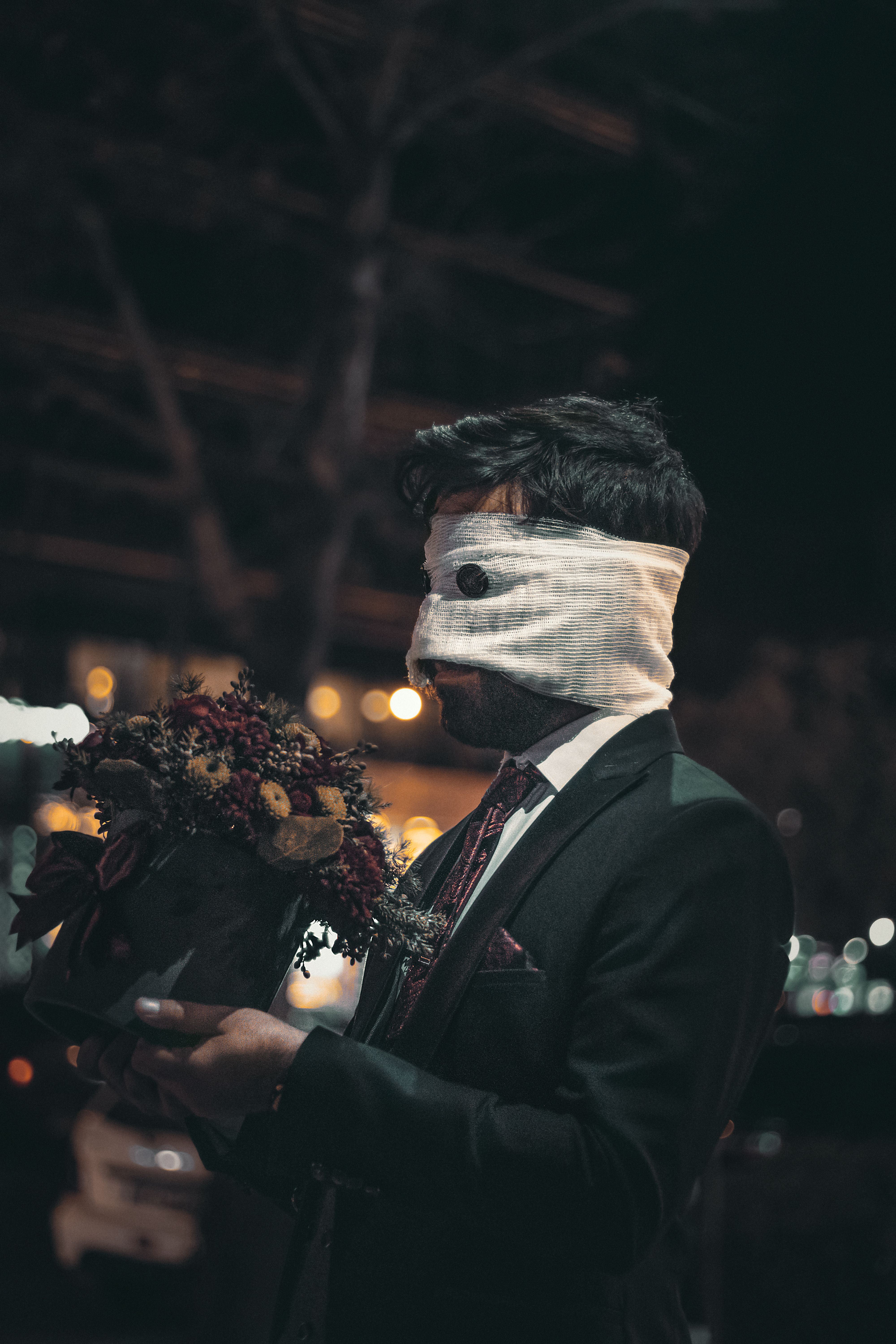 Man in Black Suit Jacket Wearing White Mask · Free Stock Photo