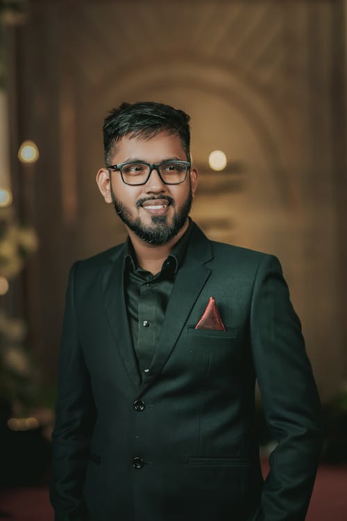 A Man in Black Suit Jacket Wearing Black Framed Eyeglasses