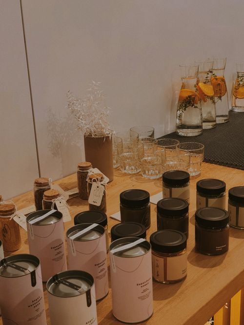 Free A warm and inviting café setup with jars and infused water on display, offering a cozy ambiance. Stock Photo