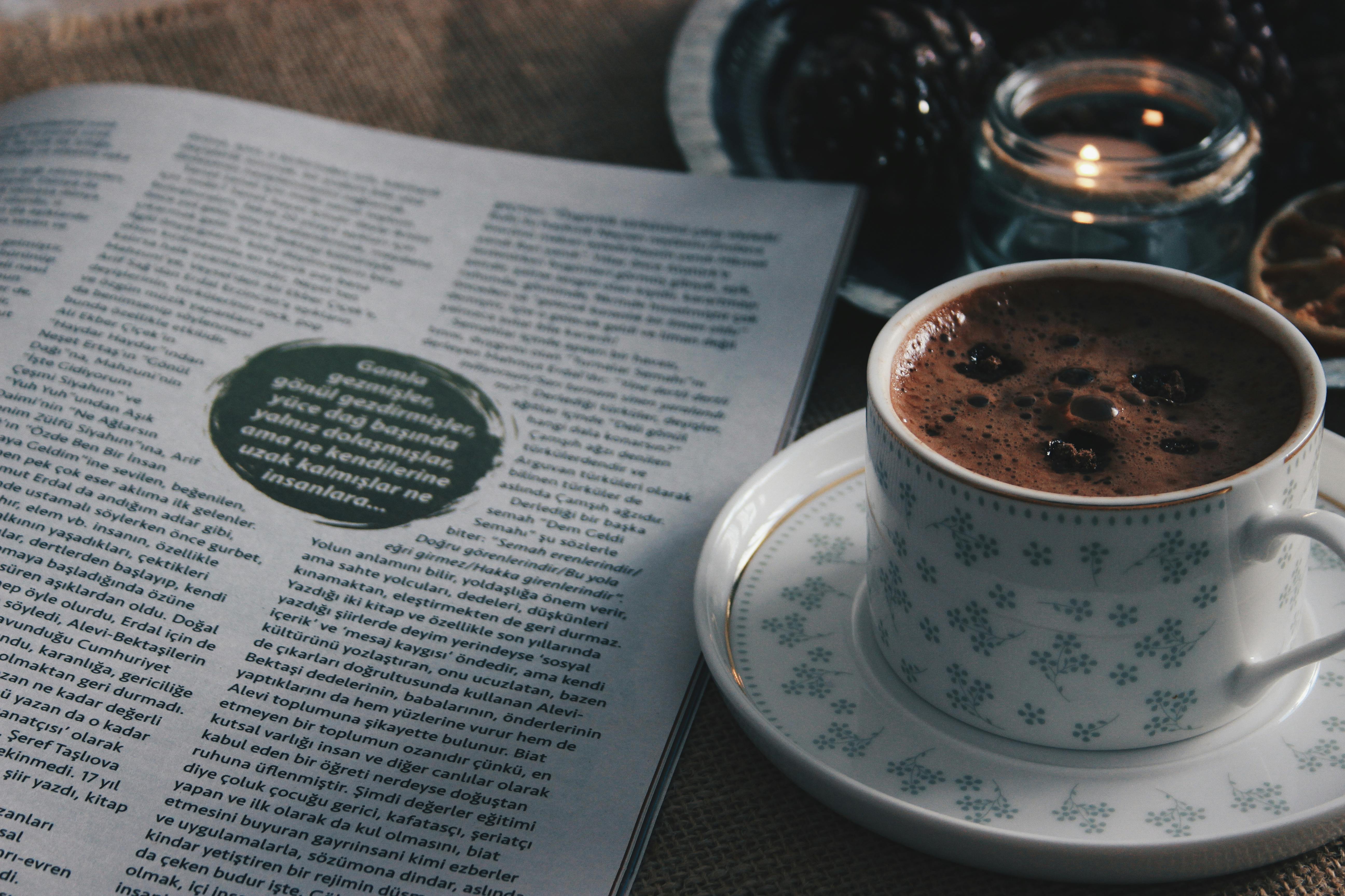 Cup of Coffee, White Flowers and a Magazine Lying on a Rug · Free Stock ...