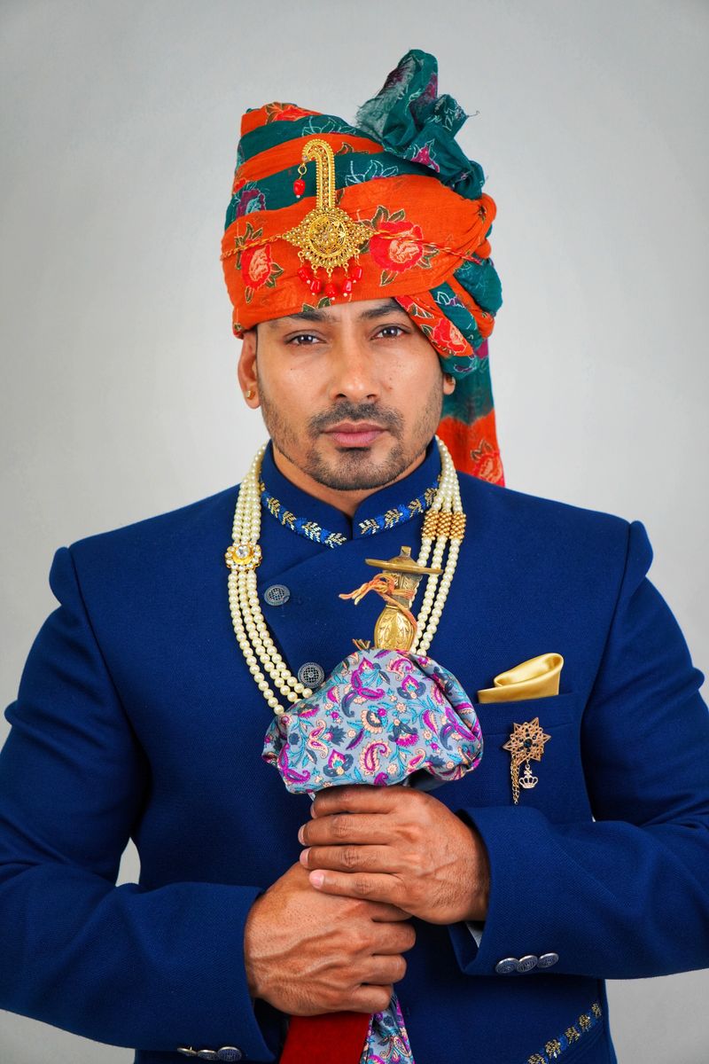 Groom in a royal blue silk sherwani with turban