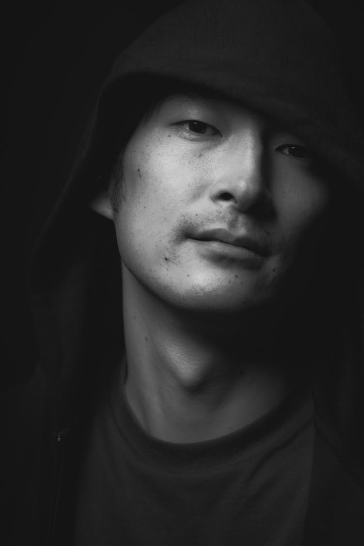 Man In Hoodie On Black Background