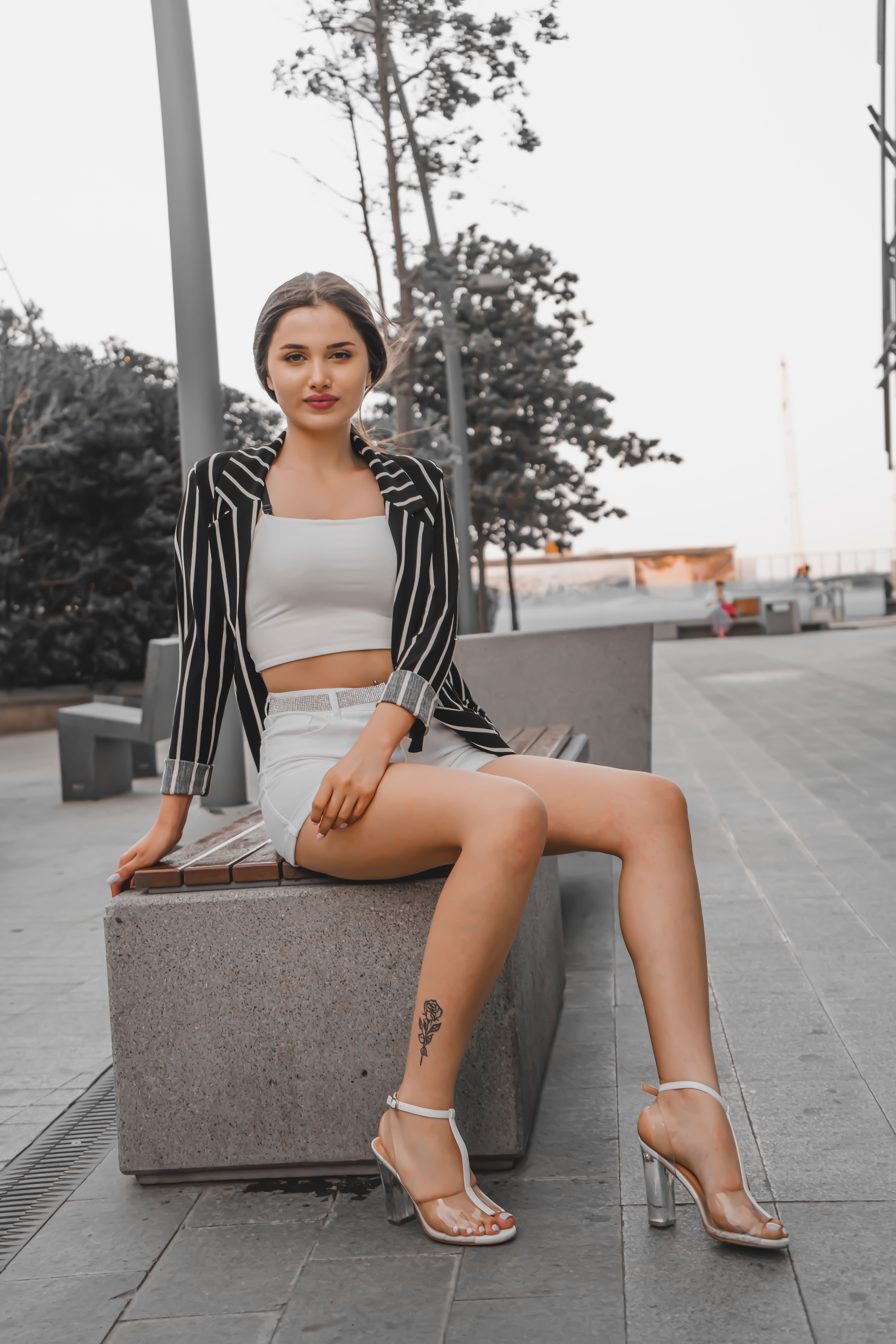 A Woman Sitting on a Concrete Bench · Free Stock Photo