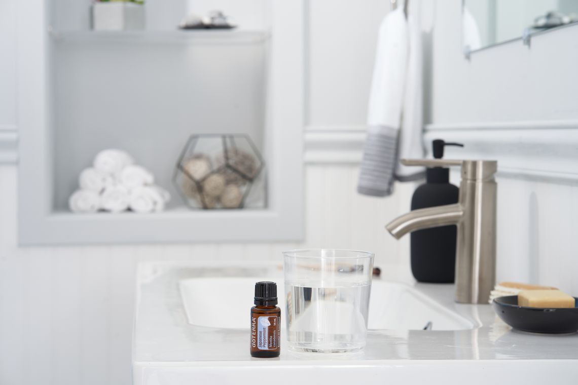 Skincare product arranged beside clean towels in a bathroom
