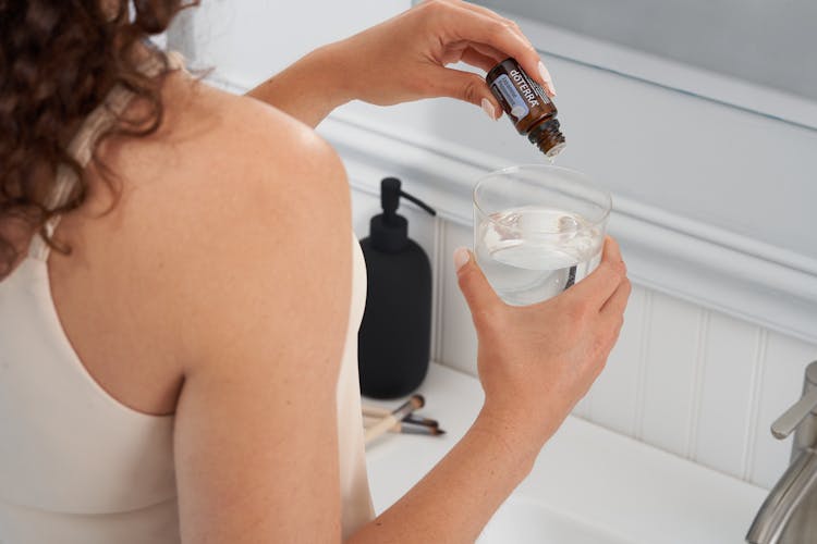 Woman Holding Cosmetics In A Bathroom 