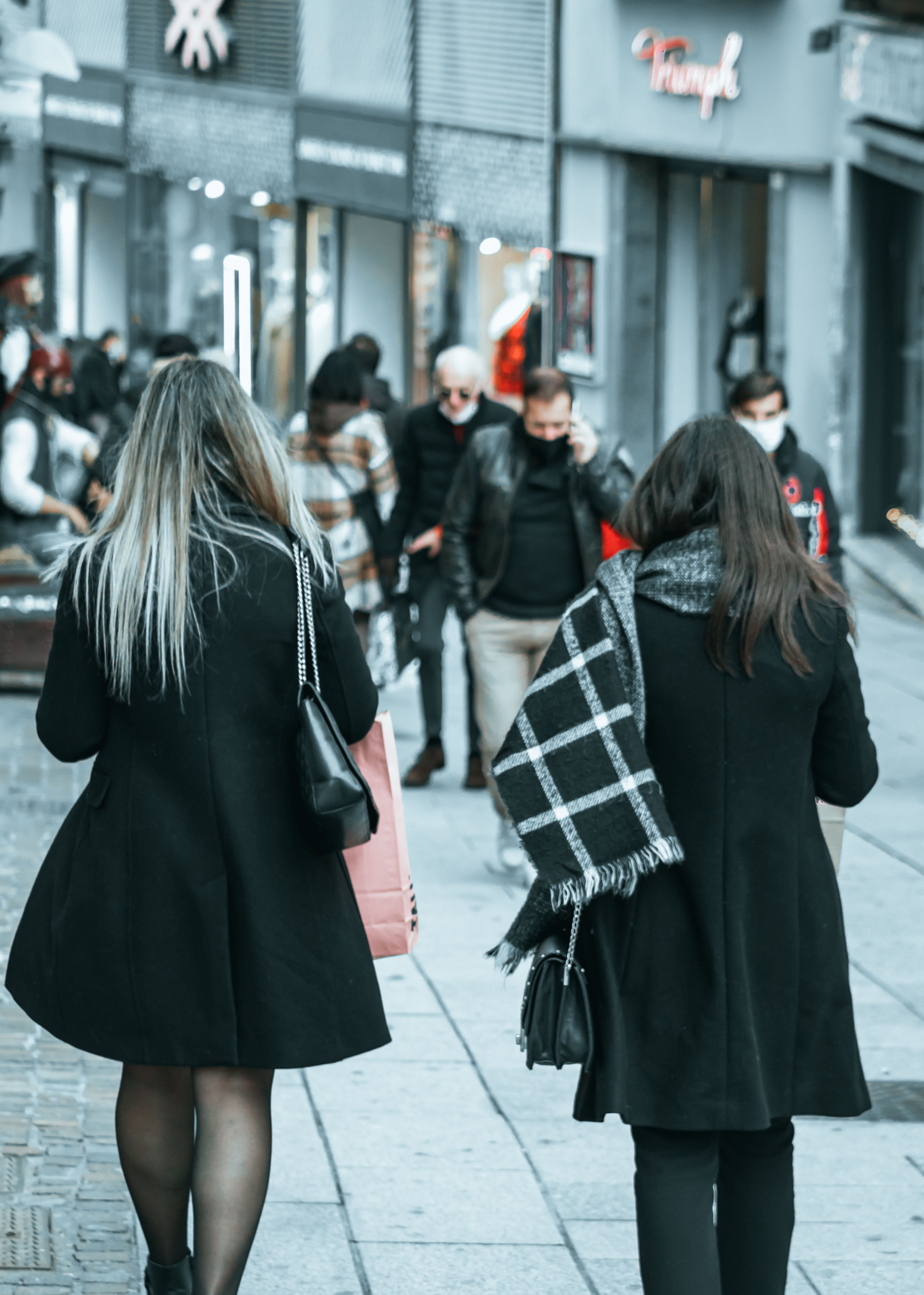 A Back View of Women in Black Coat Walking on the Street · Free Stock Photo