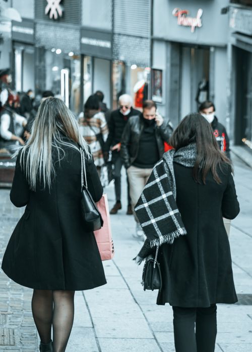 Free City street scene with people walking on a sidewalk in winter clothing. Stock Photo