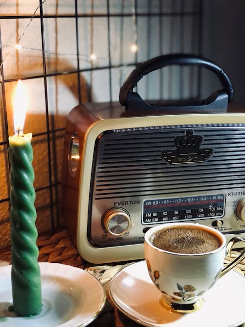 A Candle and a Coffee Cup on Saucers