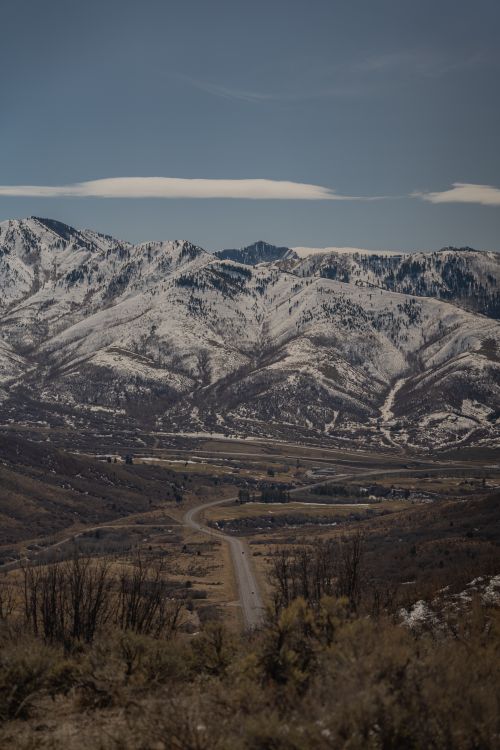Free Capture of snow-covered mountains under a blue sky near Salt Lake City, Utah. Ideal for winter travel imagery. Stock Photo