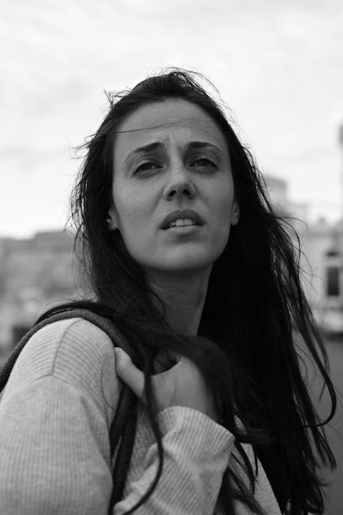 A Grayscale Photo of Woman in White Long Sleeve Shirt