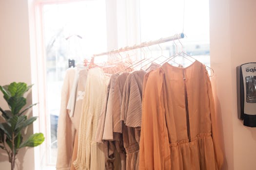 A collection of stylish dresses on hangers in a bright boutique setting.
