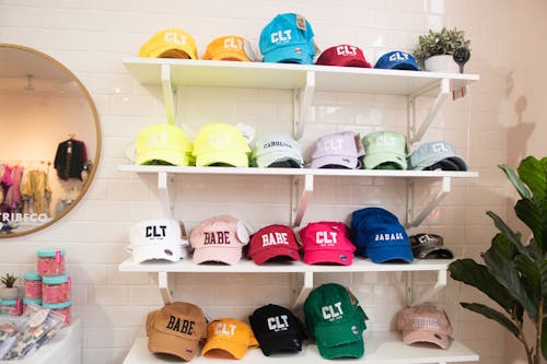 An Assorted Color of Caps on a Shelves