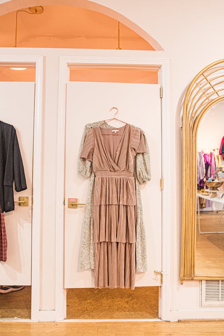 A Fitting Room Door With Hanged Clothes