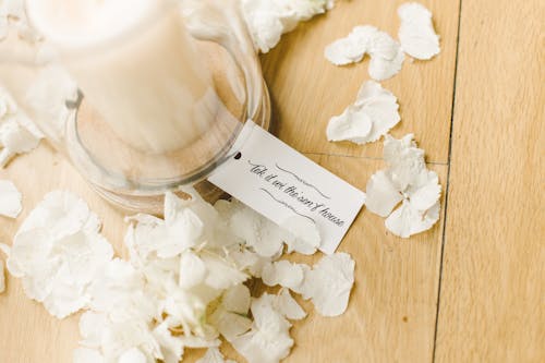 White Candle Inside Clear Glass Container