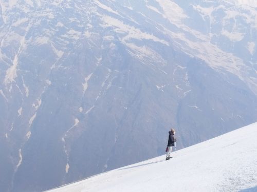 Free A trekker stands on a snowy slope in Gandaki Province, Nepal with mountains in the background. Stock Photo
