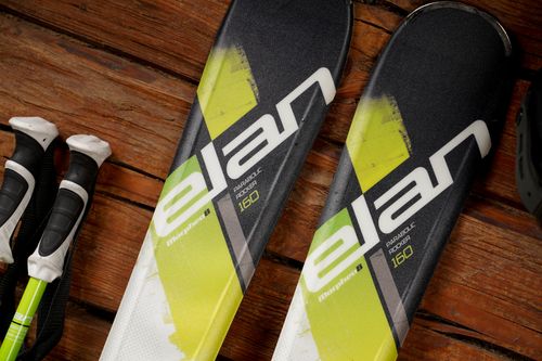 Free Detailed view of Elan ski blades with wooden background and ski gear. Stock Photo
