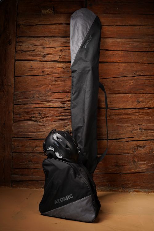 Free Skiing essentials including bag, helmet, ski bag against a wooden wall background. Stock Photo