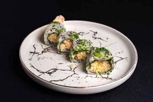 Delicious sushi rolls artfully plated on a marble design plate, highlighting fresh ingredients and vibrant presentation.