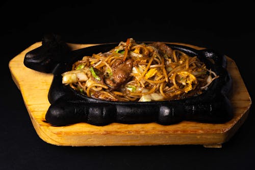 Free Noodle Dish on Black Sizzling Plate Stock Photo