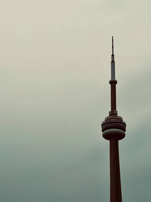 Free A vertical shot of the iconic CN Tower standing tall against a gray sky in Toronto, Canada. Stock Photo