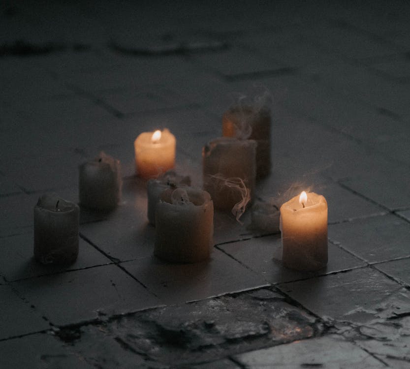 White Candles on Tiled Floor