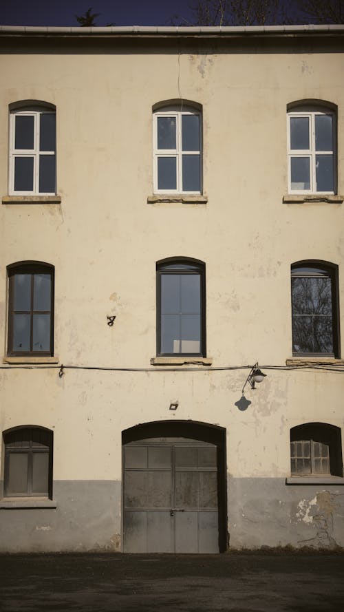 Free Abandoned Apartment Building with Arched Windows Stock Photo