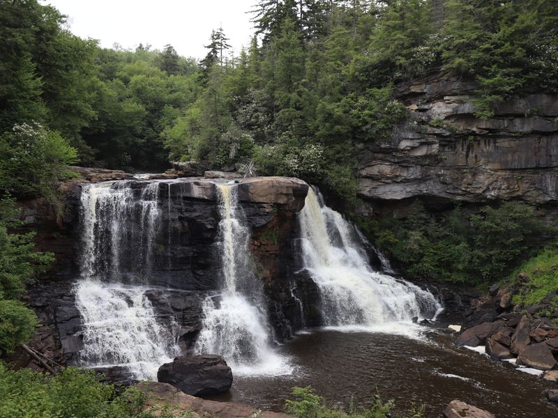 Wide river waterfall flowing over flat rocks