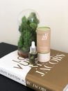 Two Brown and Green Bottles on White and Brown Book