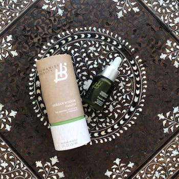 Elevate your skincare routine with Herban Wisdom Facial Oil beautifully displayed on an intricate ornate tile.