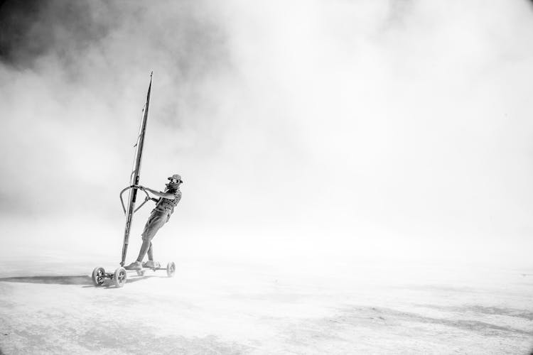 A Person Windsurfing In Land