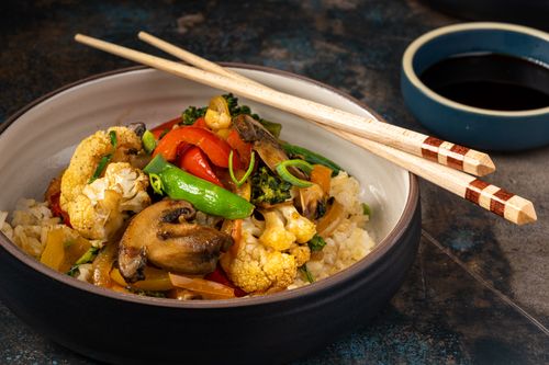 Free Colorful stir fry vegetables with rice in a bowl, featuring chopsticks. Stock Photo