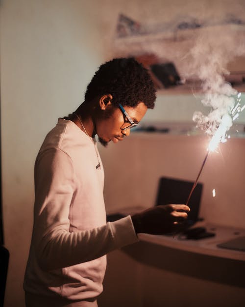 Man in White Long Sleeve Shirt Holding Firecracker