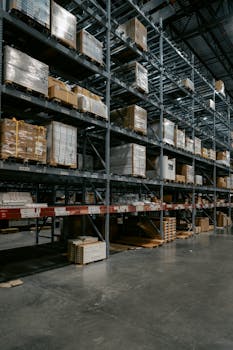 A well-organized industrial warehouse with stacked shelves and various pallets for efficient storage.
