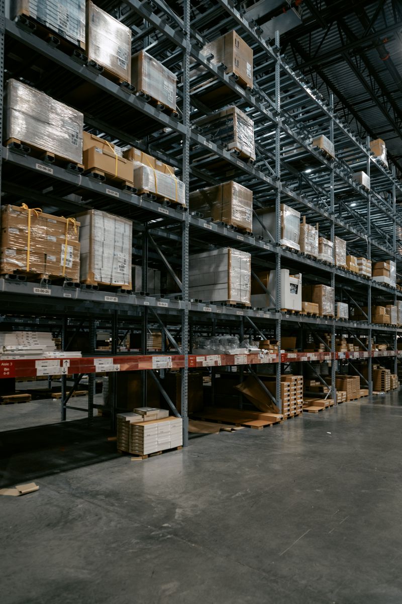 Well-organized industrial warehouse interior with stacked shelves and pallets