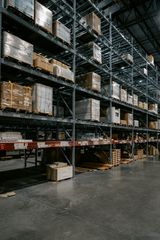 Dark warehouse interior with pallets on shelving