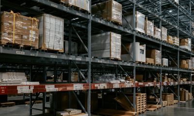 Dark warehouse interior with pallets on shelving