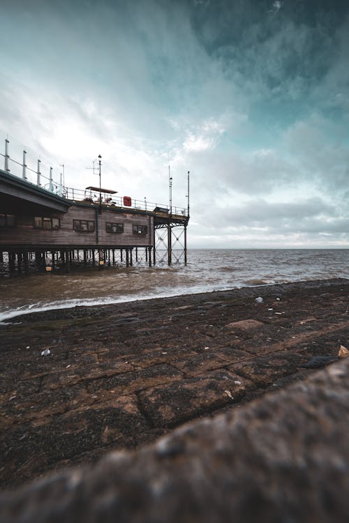 Pier on Sea Shore under Clouds