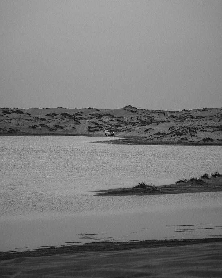 Car On Shore Among Desert Dunes