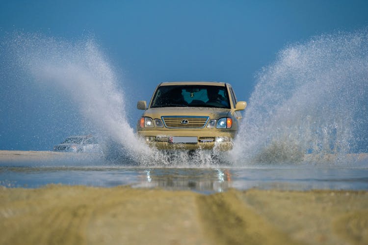 Car Splashing Water In Puddle