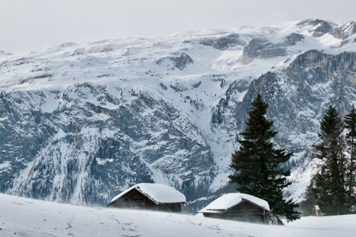 Free Snow-covered cabins in Trentino-Alto Adige with stunning mountain views. Stock Photo