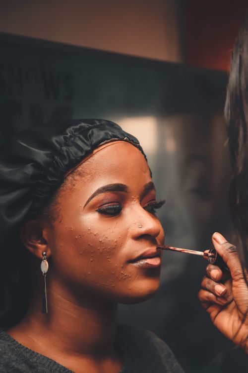 Free Close-up of a woman having makeup applied, highlighting beauty and style. Stock Photo