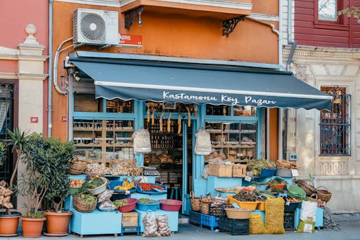Charming market stall displaying a variety of fresh vegetables and fruits in an urban setting.