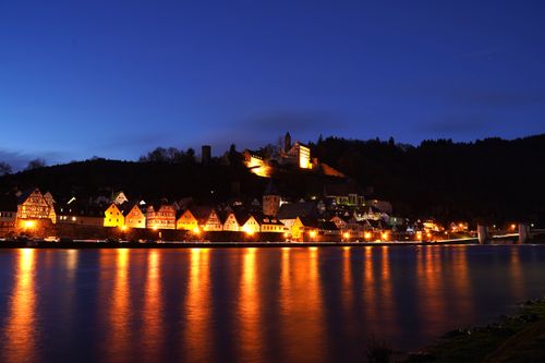 Free Scenic view of a German riverside town illuminated at night with water reflections. Stock Photo