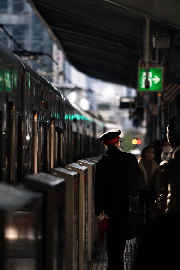 Worker In Hat By Train On Train Station