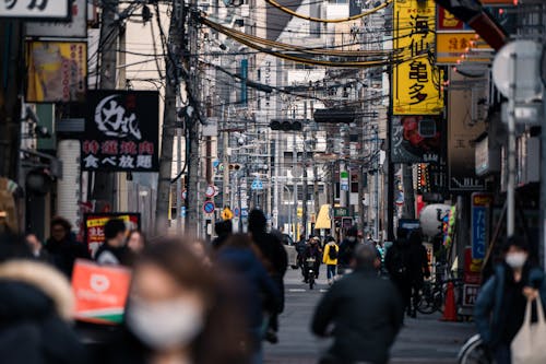 People Walking in a Busy Street in Osaka