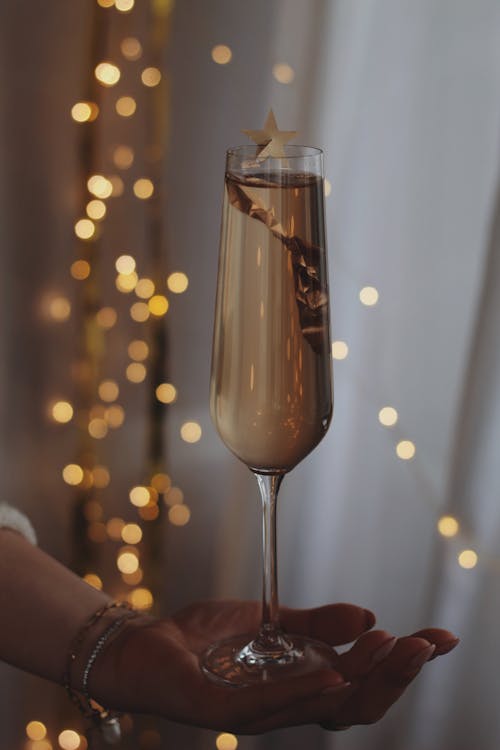 Woman Hand Holding Decorated Glass of Champagne