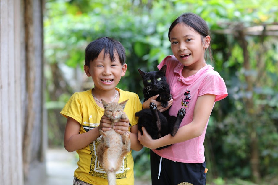 Smiling Children Holding Cats