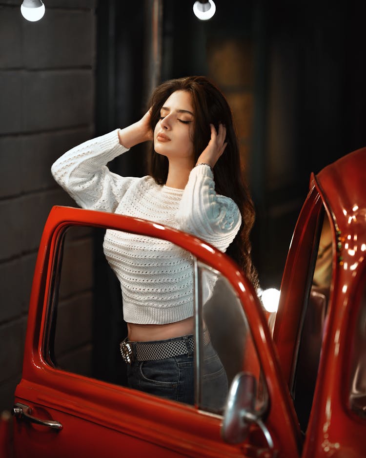 Woman In White Sweater Exiting Red Car