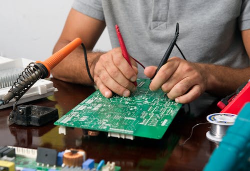 Technician Repairing an Electronic Device 